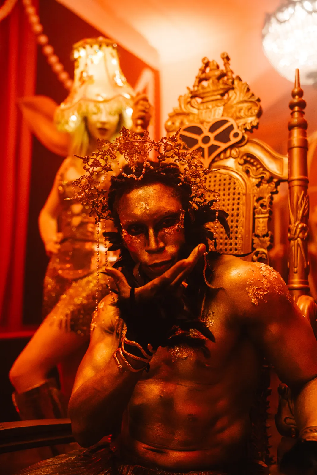 Gold-painted guest on an ornate throne