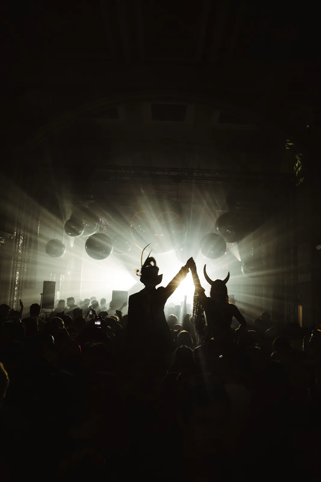 Crowd silhouettes against stage light in the church